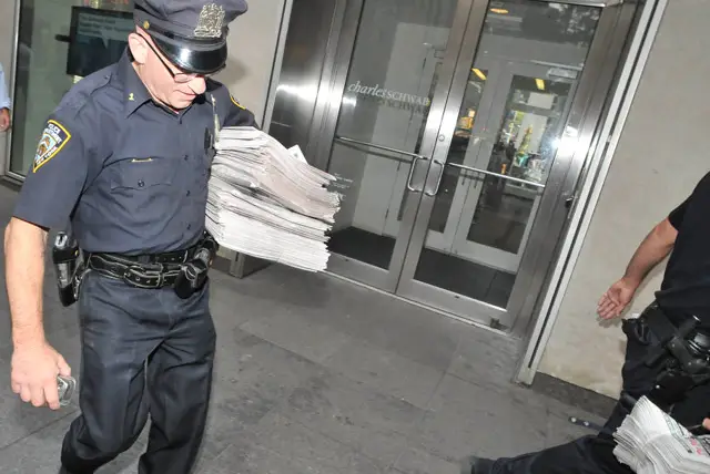Police confiscate fake copies of the New York Post outside News Corp. headquarters.